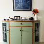 Green cabinet white wall