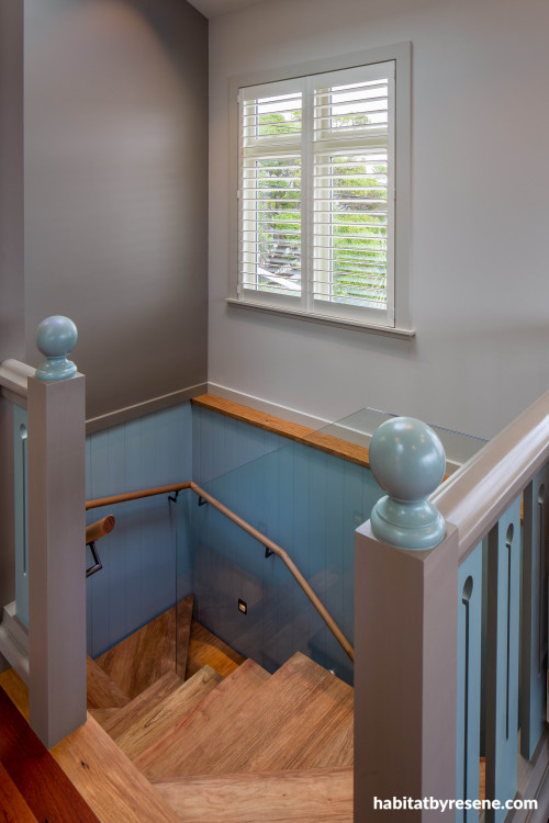 Natual wood staircase with walls painted half in grey and half in blue