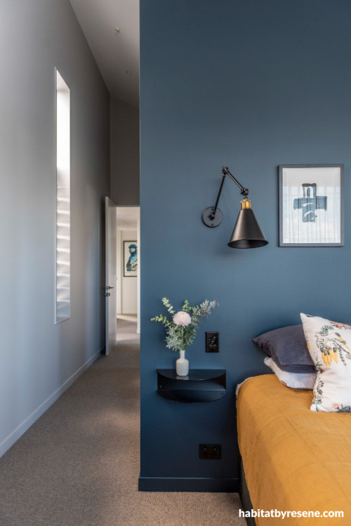 Slate blue and white coat adjacent walls in master bedroom