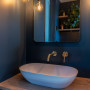 Master en-suite painted in deep navy blue combines luxury and moody atmospheres