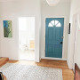 Blue door in white hallway