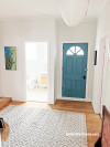 Blue door in white hallway