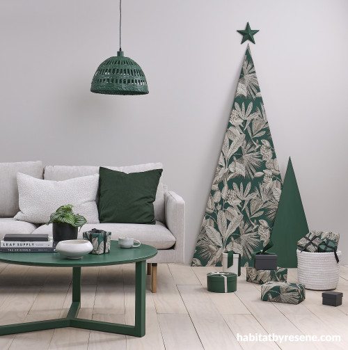 Green table in white living room at Christmas