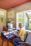 Home office with hardwood floors and white walls