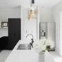 The heart of the home is a dreamy scene. The kitchen is bright and welcoming with Resene Black White on walls and ceiling, with trims in Resene Alabaster. Contrasting dark cabinetry and fixtures provide continuity from the exterior, creating a neutral hom