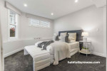 The gentle grey of Resene Wan White on the walls creates a charming and timeless feel in this bedroom, while the skirting and trims in Resene Eighth Black White provide a seamless transition from outside to in.