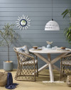 These coastal blue weatherboards are painted in Resene Baring Head, while the deck is stained in Resene Woodsman Uluru. 