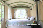 Shepherd's hut in country garden