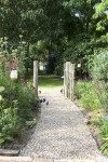 An enchanting cottage garden with a cute-as-a-button Shepherd's Hut