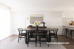 Timeless neutrals bring this dining room to life, brightening the space and creating a stunning contrast to the flooring and dark furniture. 