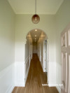 The hallway walls are painted in Resene Merino, with lower panelling and ceiling in Resene Alabaster. The front door is in Resene Blanched Pink. 