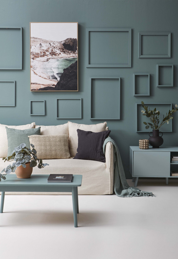 In this harmonious space, the wall and frames are painted in Resene Thor, floor in Resene Merino, coffee table in Resene Thor, console table in Resene Sorrento and short bobble vase in Resene Gargoyle. Sofa from Nood, black vase from Spotlight, black cushion from H&amp;amp;amp;amp;amp;amp;amp;amp;amp;amp;amp;amp;amp;amp;amp;amp;amp;amp;amp;amp;M Home, artwork and plant pot from Freedom, faux eucalyptus leaves, throw and other cushions from Adairs. Project by Vanessa Nouwens, image by Wendy Fenwick.  