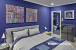 Bedroom with purple walls and white trims creates vibrant atmosphere 