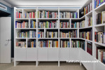 Home library painted in white creates sophisticate space.