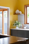 Sunny yellow painted on kitchen walls 