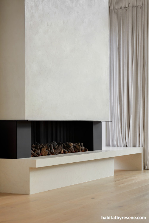 Modern fireplace featuring custom beige plaster painted in Resene Quarter Bison Hide