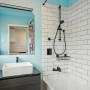 Bathroom featuring white tiles and sky blue walls