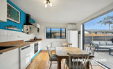 Kitchen with white walls and blue feature wall