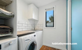 White laundry with a light blue door and back wall