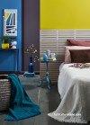 Bedroom featuring bright yellow and blue walls