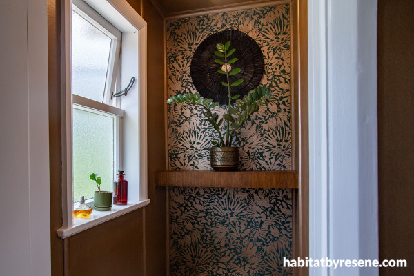Window with patterned floral wallpaper on the adjacent wall.