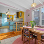 Dining room featuring soft pink walls and kitchen featuring bright yellow walls and soft blue cabinetry