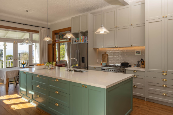 This charming kitchen is painted in a mix of gentle hues. Resene Cutty Sark was used on the kitchen island, with Resene Quarter Taupe Grey on the cabinets and Resene White on the ceiling. Timber trims are finished in Resene Aquaclear.  
