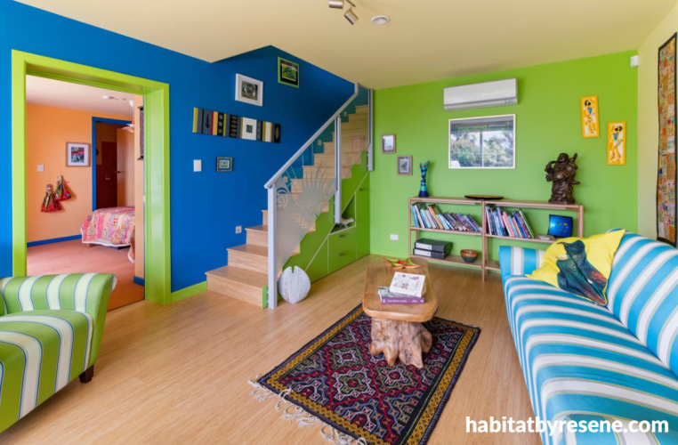 Downstairs living room featuring blue and green walls