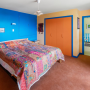 Bedroom featuring bold blue and pale orange walls