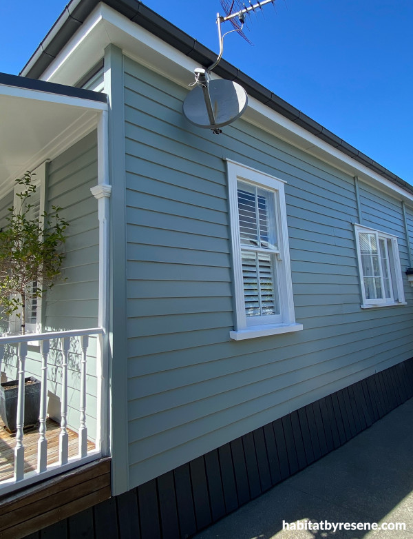 The baseboards, which anchor the house, are painted in Resene Ironsand, a smoky, dark brown. The weatherboards are painted in Resene Inside Back with trims and detailing in Resene Half Black White. 