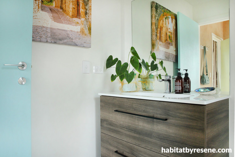 Bathroom featuring soft white walls and pale blue doors