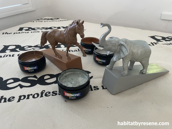 Animals on doorstops with paint pots