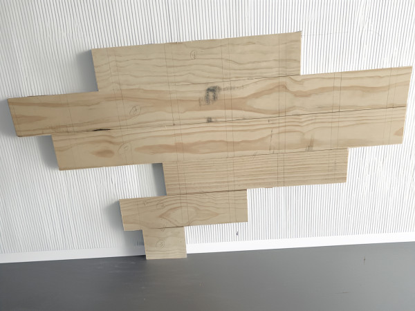 Strips of wood with markings in pencil for cutting