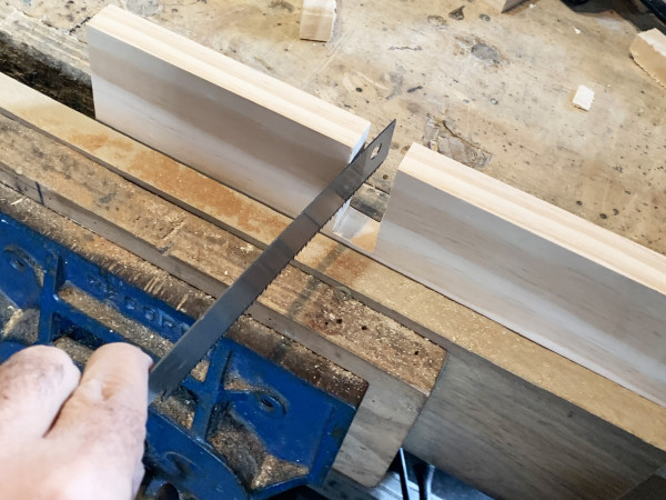 A piece of wood and a saw showing a cut out piece