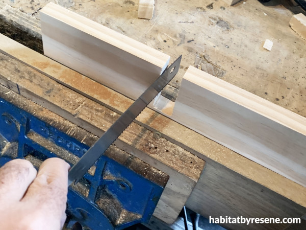 A piece of wood and a saw showing a cut out piece