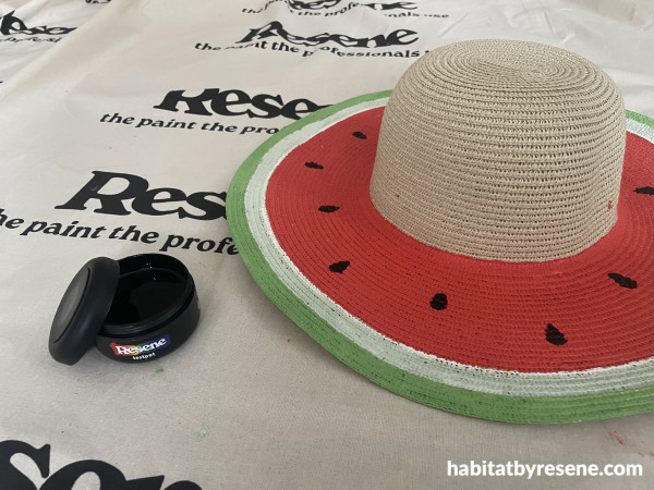 A hat painted with a watermelon pattern