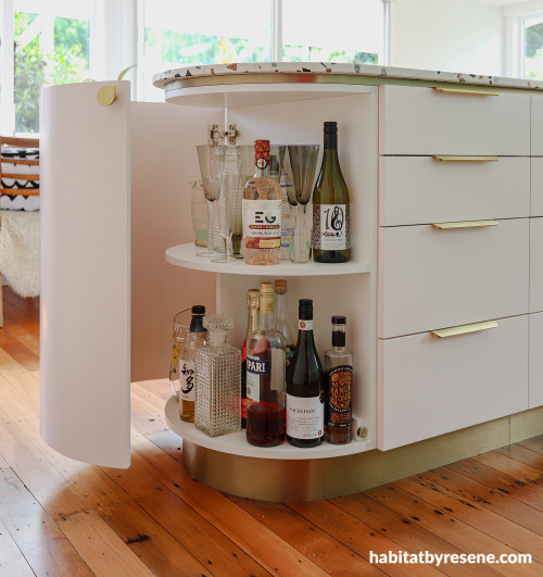 Kitchen island featuring hidden bar