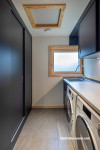 Laundry, dark laundry, laundry featuring contrasting walls and wooden trims