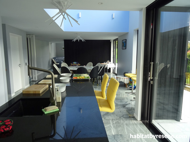 Kitchen and open plan living area, pale grey and black open plan kitchen