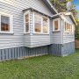 House exterior painted in Resene Half Silver Chalice with smoky blue frames in Resene Snapshot