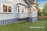 House exterior painted in Resene Half Silver Chalice with smoky blue frames in Resene Snapshot