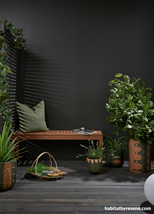 Dramatic dark outdoor patio featuring Resene Karaka