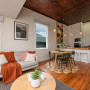 Kitchen and dining area with Resene Colorwood Dark Rimu ceiling walls and trims painted in Resene Milk White.