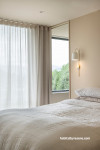 Neutral bedroom painted in Resene Double Biscotti and Resene Quarter Biscotti