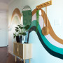 Hallway featuring mural painted in Resene Toffee, Resene Paper Doll, Resene Cutty Sark and Resene Swamp with walls in Resene Alabaster