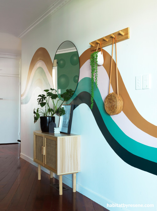 Hallway featuring mural painted in Resene Toffee, Resene Paper Doll, Resene Cutty Sark and Resene Swamp with walls in Resene Alabaster