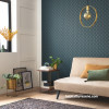 Living area featuring statement teal blue wallpaper with subtle geometric pattern