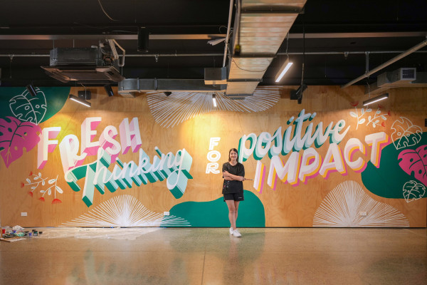 Merinda Chong with her mural for GridAKL, painted in Resene Bingo, Resene Scandal, Resene Guardsman Red and Resene Bright Spark. 