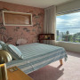 Bedroom featuring Resene wallpaper and painted in Resene Rainee and Resene Half Wheatfield