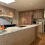 Kitchen with wood features and painted in Resene Wheatfield